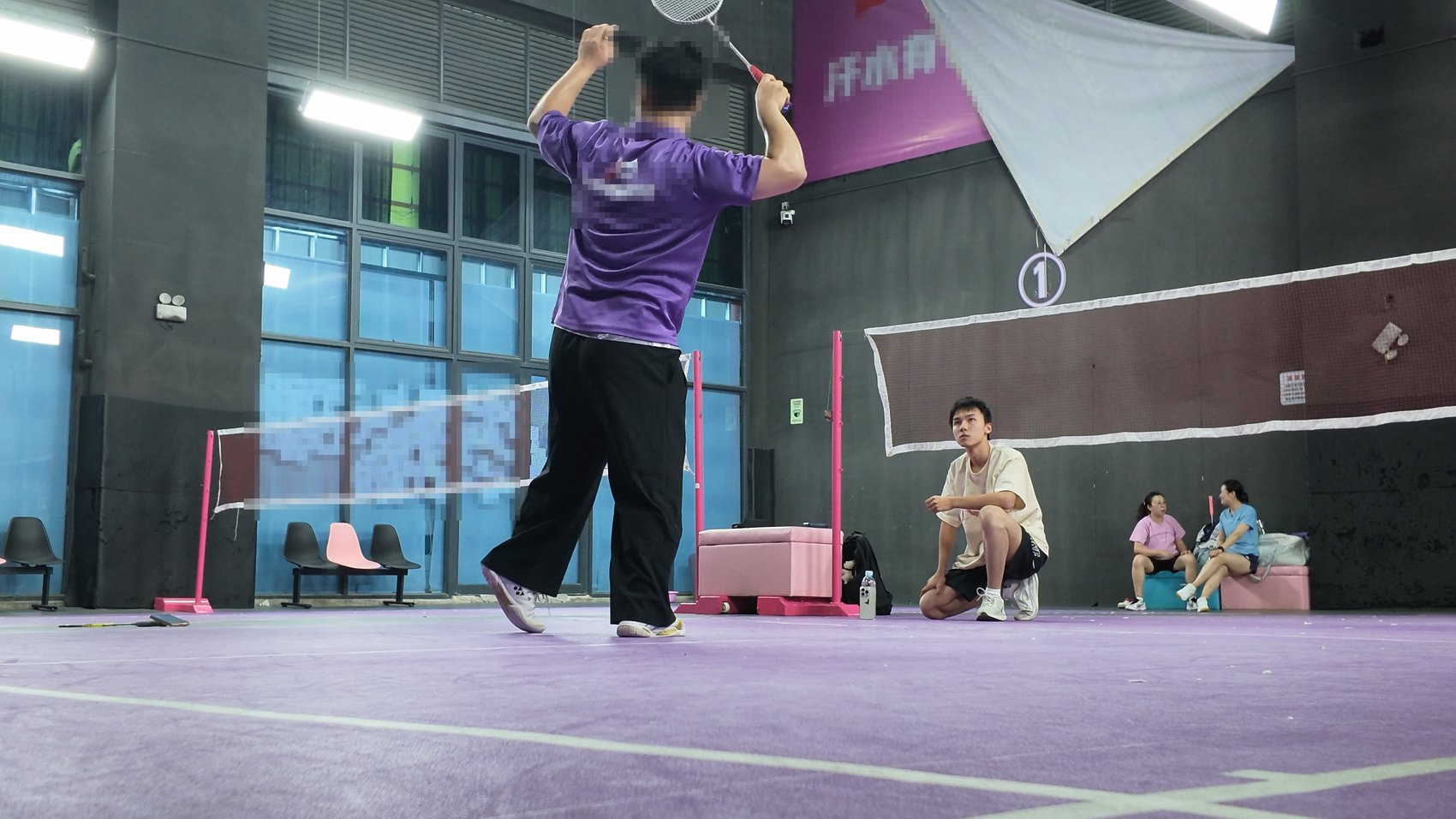 A professional club coach demonstrating a clear on court